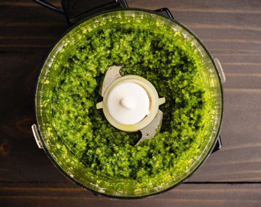 Top rated food processors with vibrant green pesto sauce