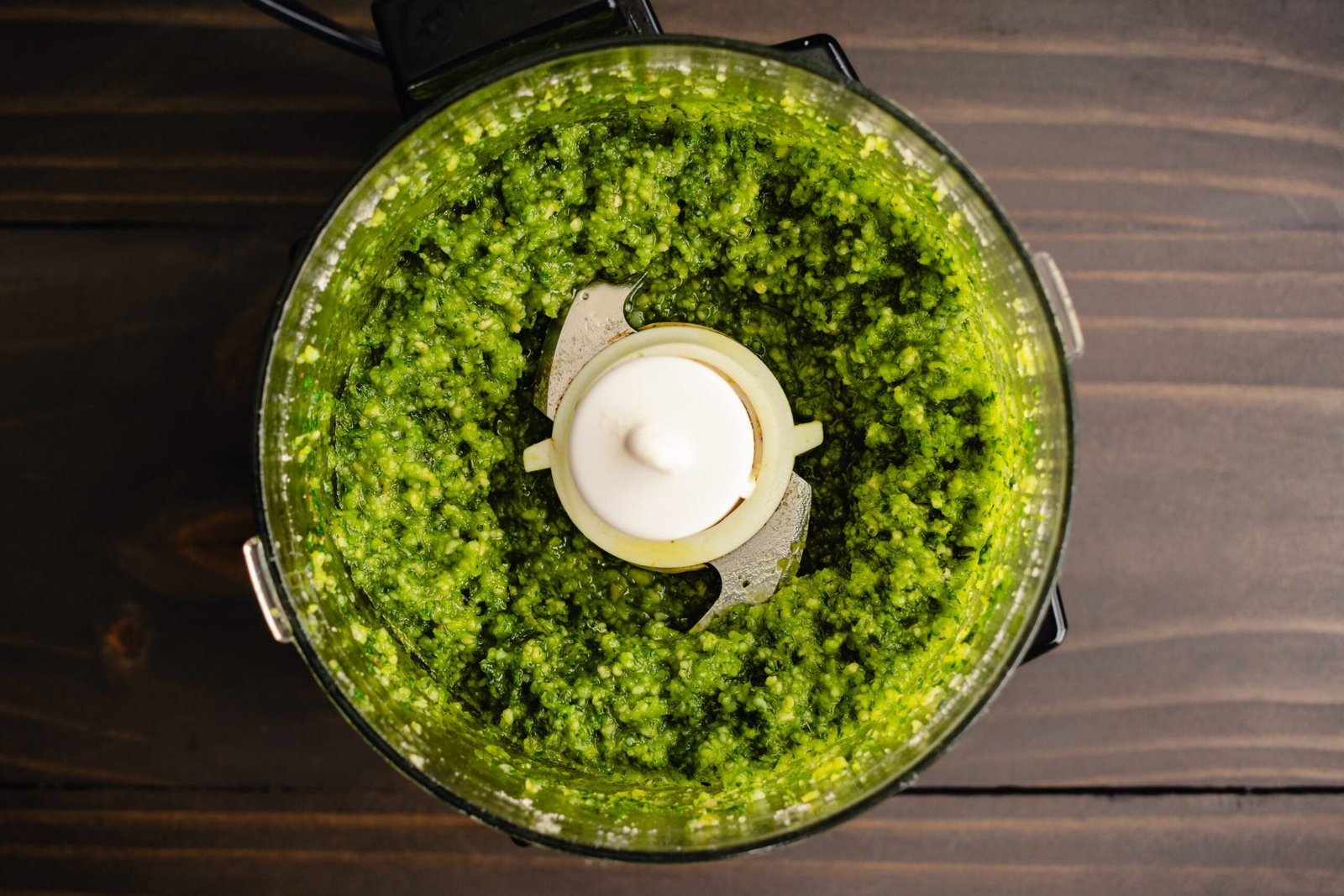 Top rated food processors with vibrant green pesto sauce
