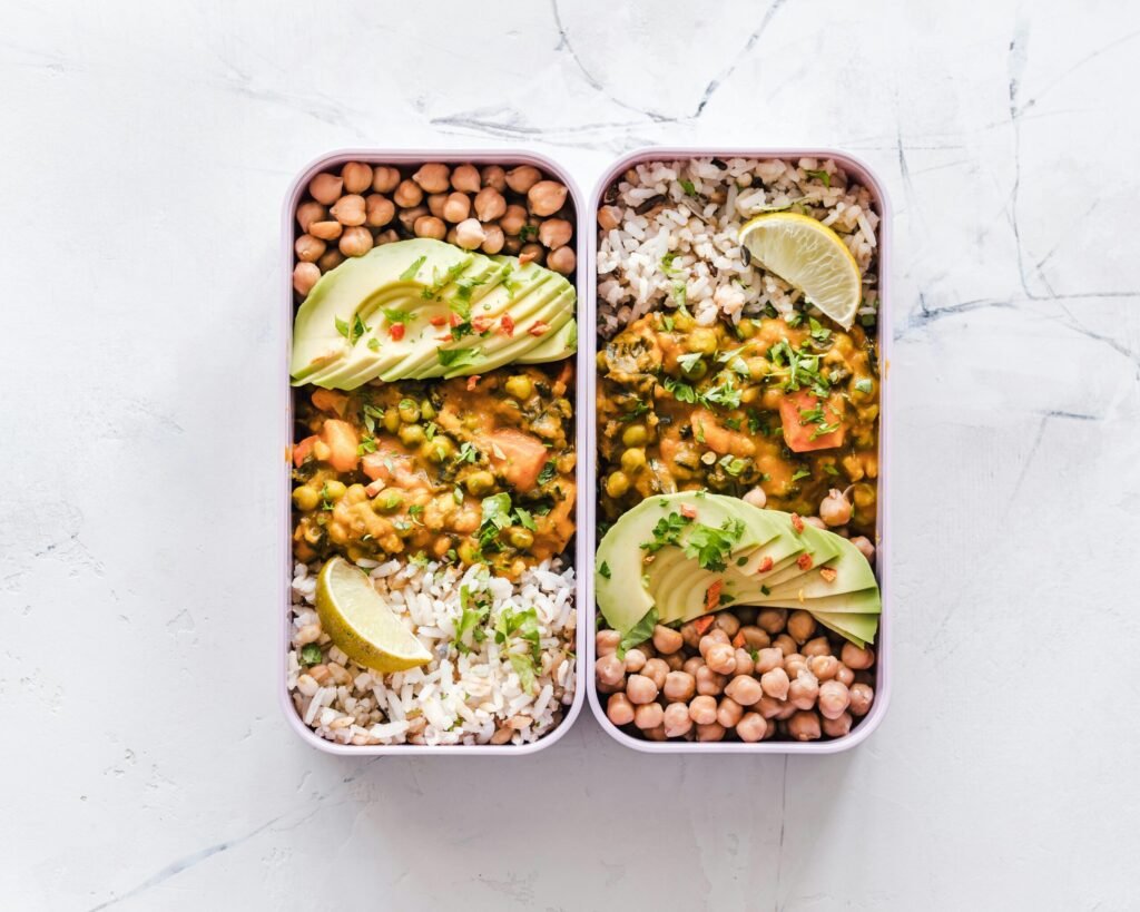 Batch cooked vegetarian meals with beans in meal prep containers for weekly cooking