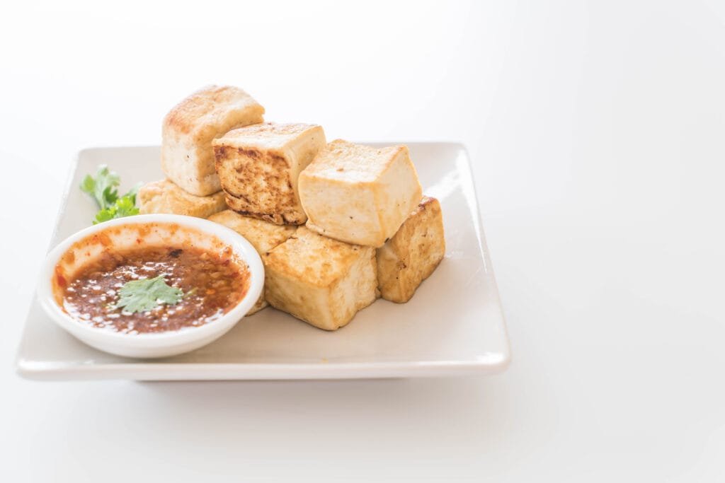Fried tofu with a spicy peanut sauce for a healthy vegetarian meal